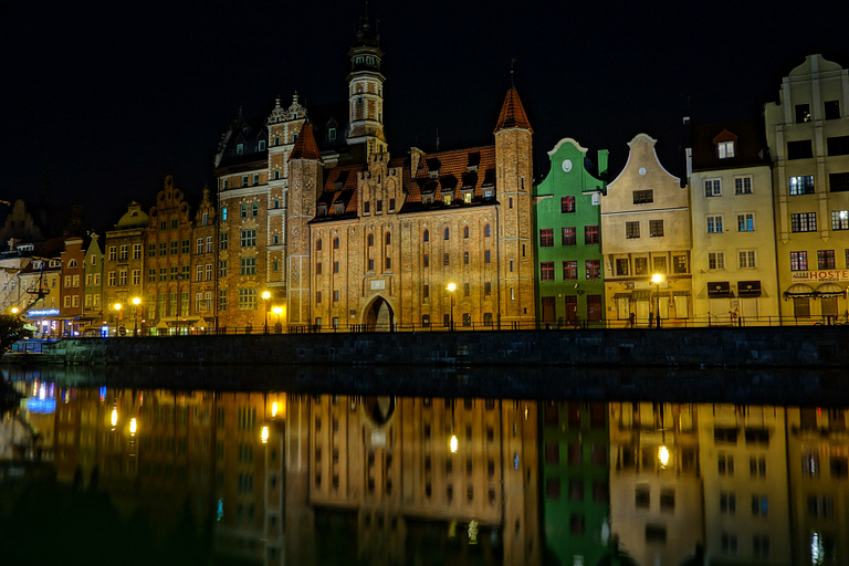 Old town section of Gdansk, Poland, reflected in the water at night.