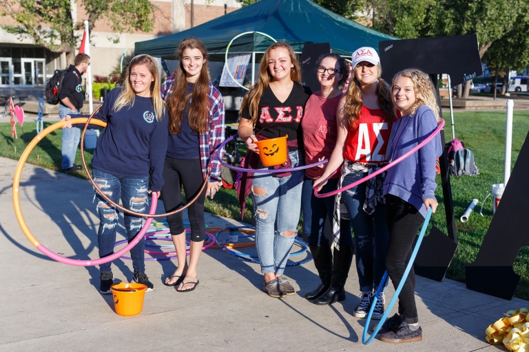 Six sorority members pose with hula hoops outside on the IUPUI campus.