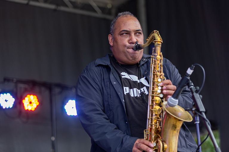 Rob Dixon blows his saxophone.