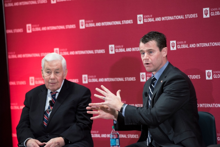 Todd Young, right sits on stage with Richard Lugar at the America's Role in the World conference.