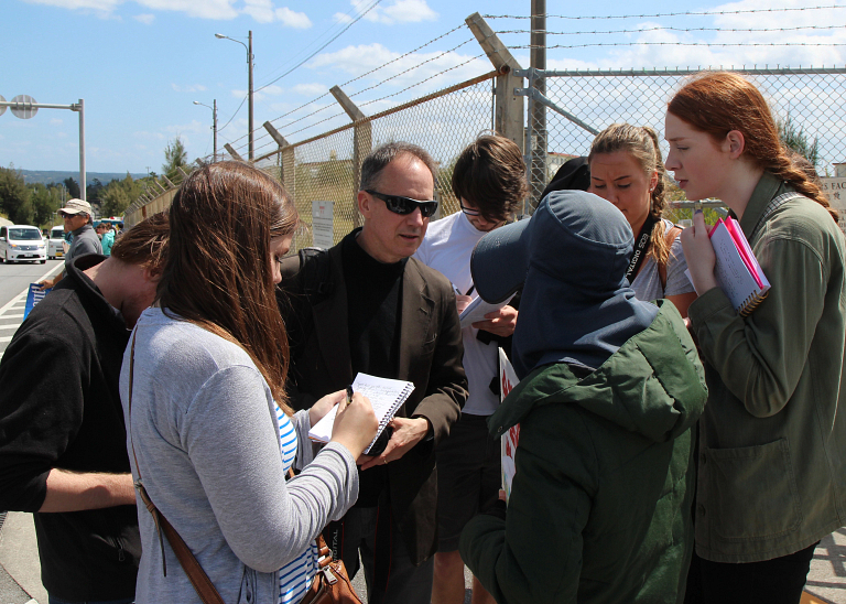 Joseph Coleman talks with students during an international trip to Japan