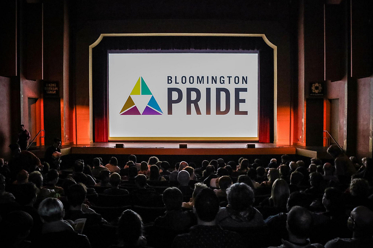 A theater with Bloomington Pride on the screen