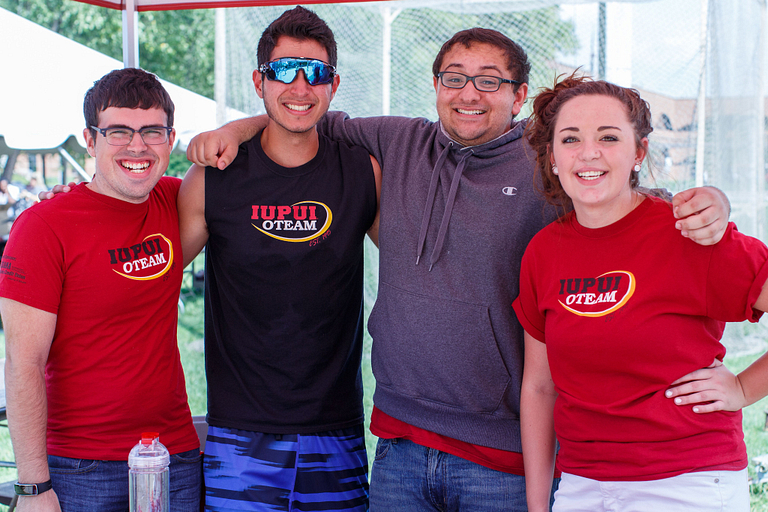 Four smiling students.