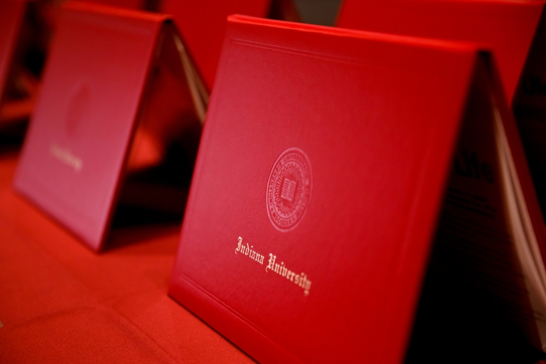 A row of red Indiana University diplomas