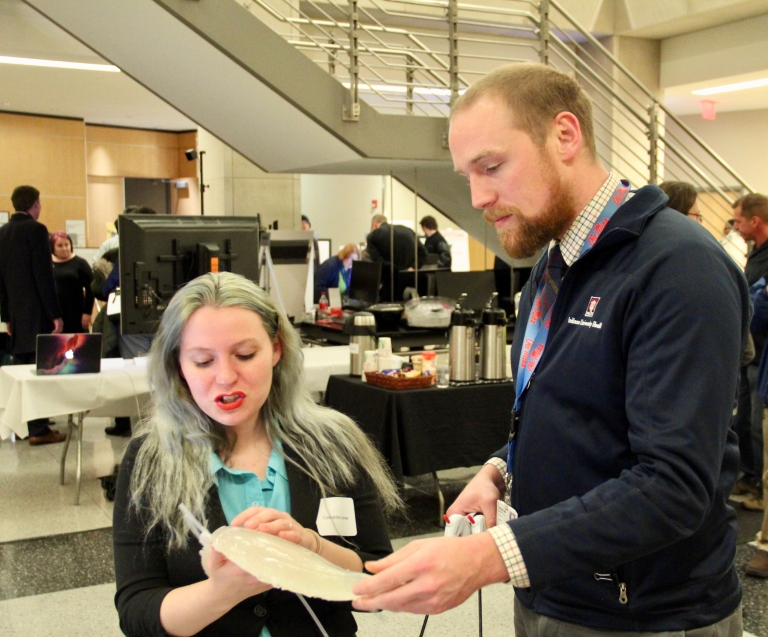 Cassandra Jones shows a 3-D printed liver to John Martin.