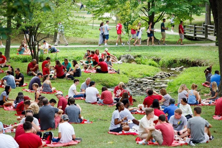 Students and families picnic near the Jordan River
