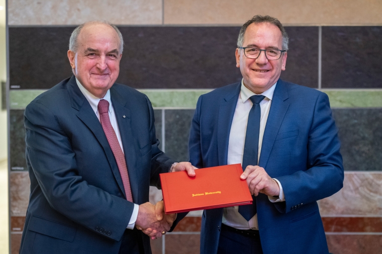 The IU president and Sorbonne University president hold a signed agreement
