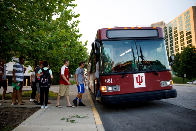 People boarding a campus bus
