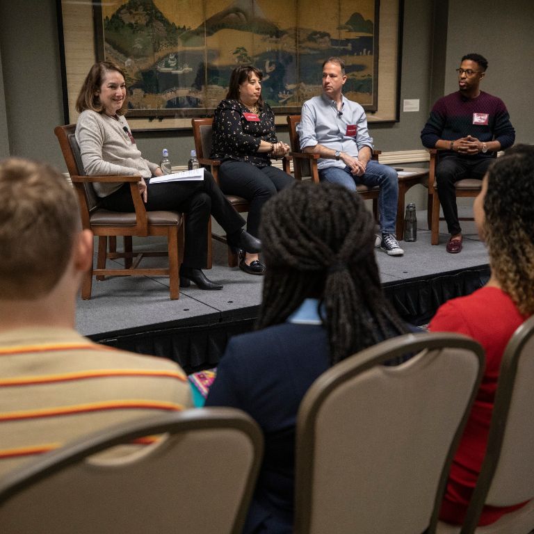 Four alumni speak on a panel 
