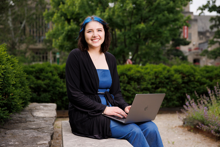  Kathryn Riordan sits outdoors with a laptop