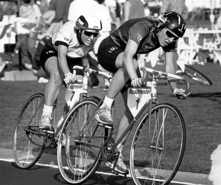 Two cyclists compete against each other in the 1988 women's Little 500.