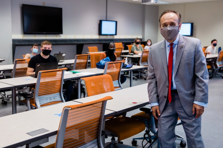 Chancellor Paydar standing in a classroom while wearing a mask