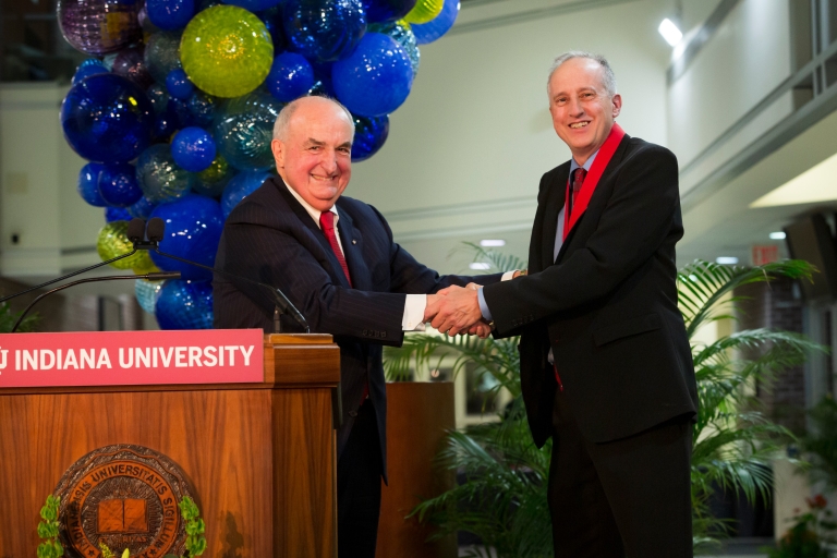 IU President Michael McRobbie shakes hands with Jeffrey Palmer