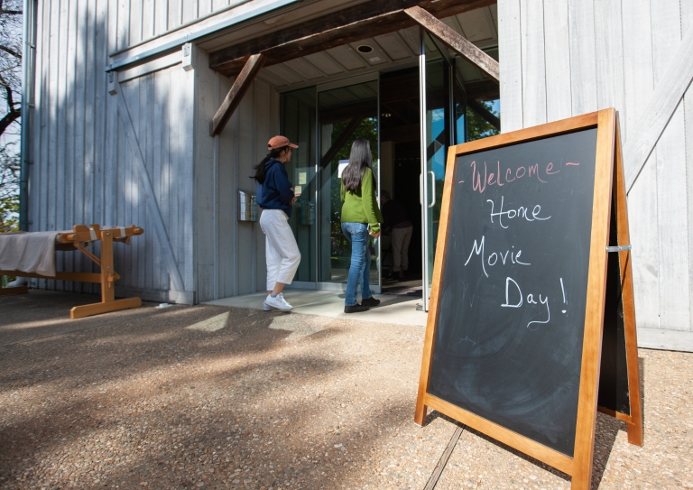 A sign for Home Media Day sits outside of an entrance to the Wylie House Museum