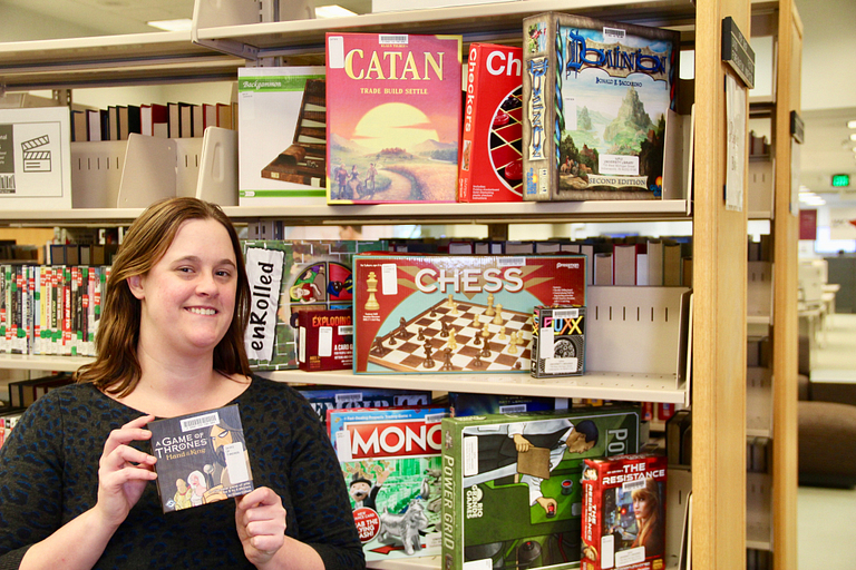 Caitlin Pike displays games at the library.
