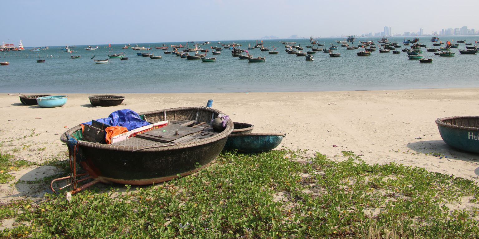 A boat sitting on the shore of the Da Nang in Vietnam.