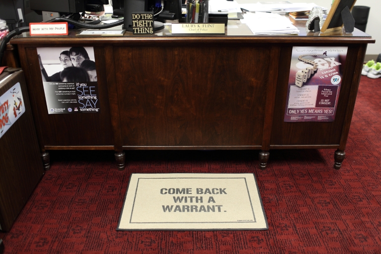 A doormat in the police station says "Come back with a warrant."