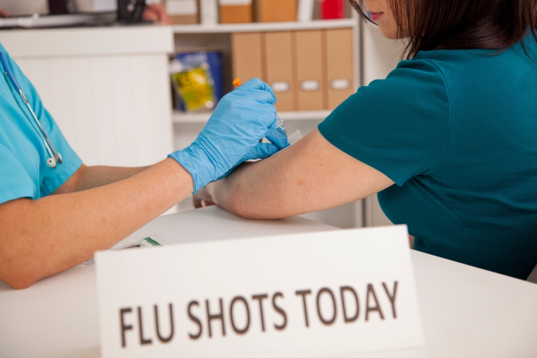 Health professional administering a flu shot