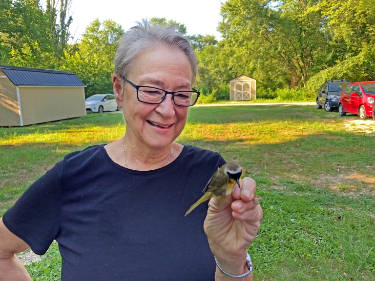 A woman holds a bird