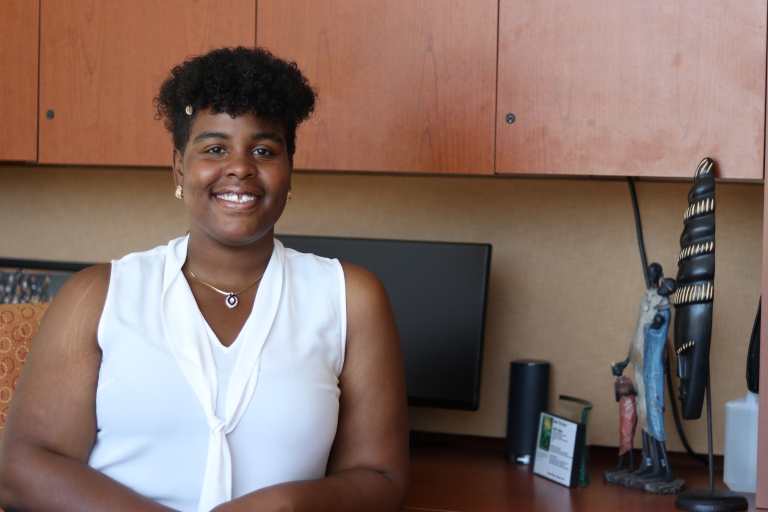Sha-Nel Henderson poses for a photo at the desk in the Black Student Union office.