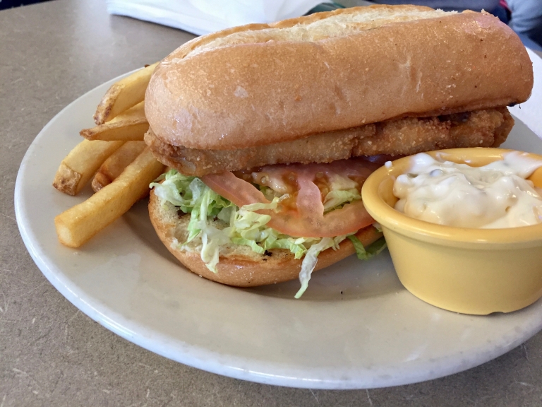 A fish sandwich, fries and tartar sauce from Workingman's Friend.