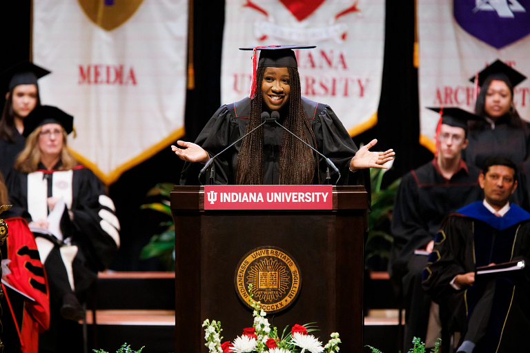 Jordan Davis speaks at an honors convocation dressed in a cap and gown
