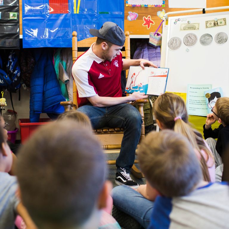 IU soccer player Andrew Gutman reads to students at Arlington Elementary School.