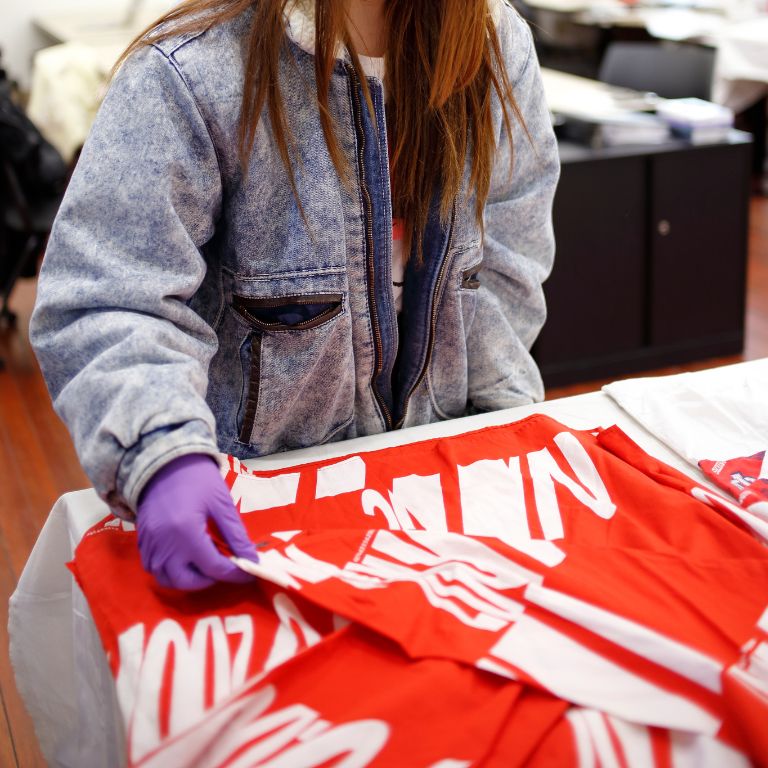 A student touches a red IU jersey 