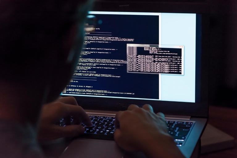 A person coding on a computer