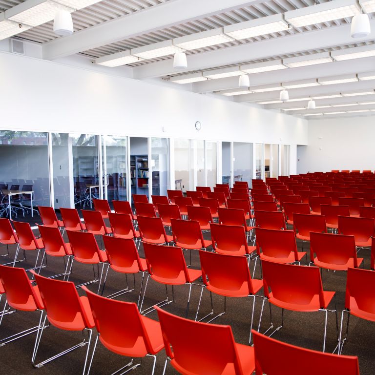 Red chairs in a lecture hall 