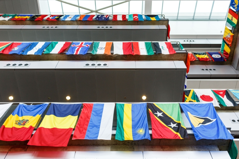 flags from countries around the world hang from all levels of the campus center atrium