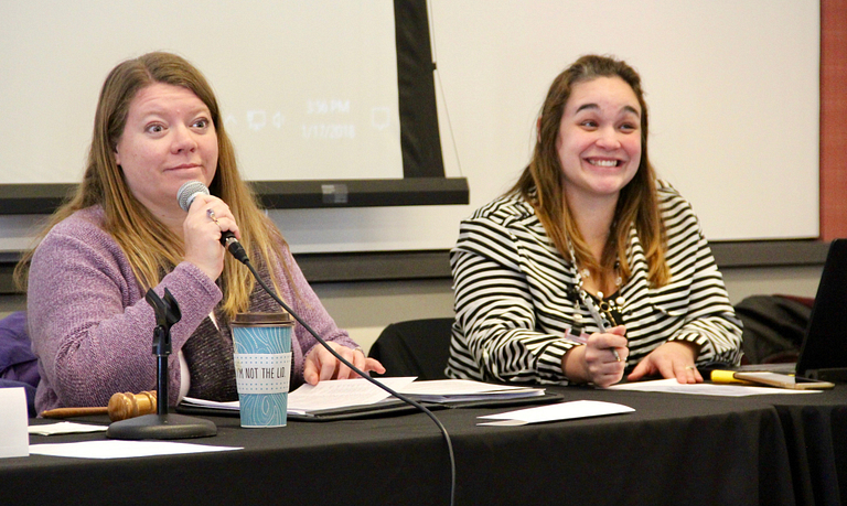 Kristy Beach and Lindsey Mosier lead a staff meeting.