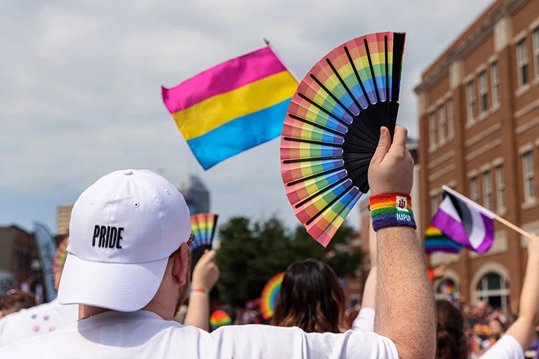 A closeup of a rainbow pride fan