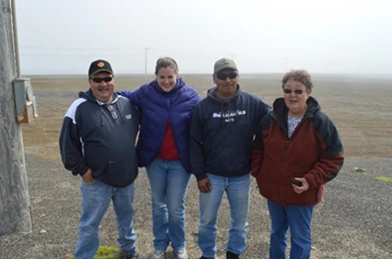 Jayne-Leigh Thomas poses with tribal leaders outside in Alaska