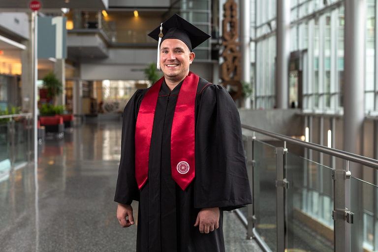 Matthew Brown wears his IUPUI commencement cap and gown