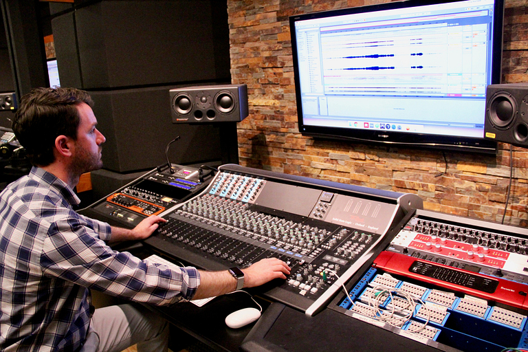 Jordan Munson works a soundboard.