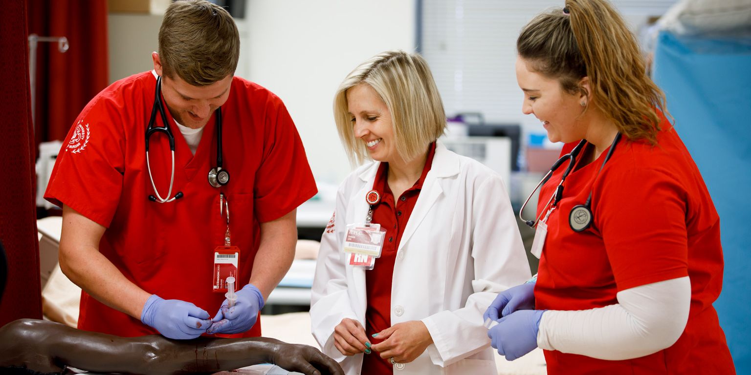 Shannon Love with students in the IUPUC simulation lab.