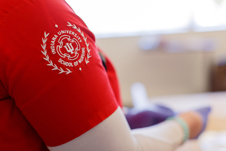 An IU nursing emblem on the are of a nurse's scrubs