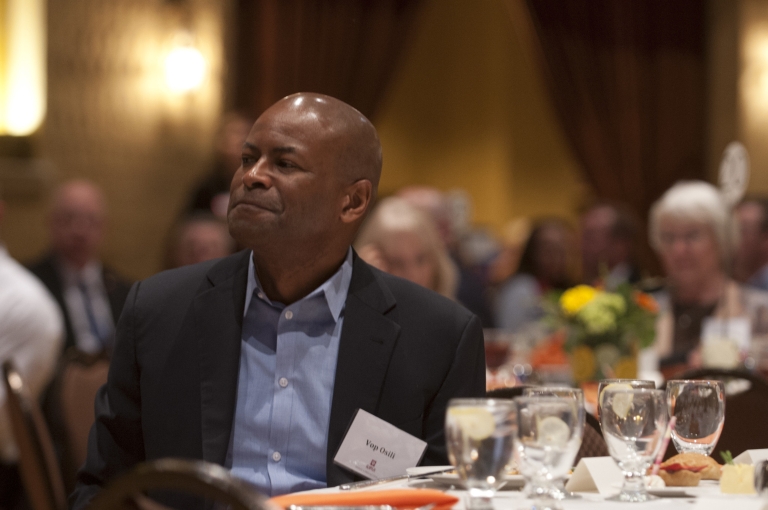 City-County Councillor Vop Osili sits at a table at the Spirit of Philanthropy awards luncheon