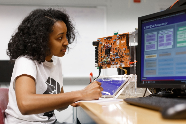 student in an engineering and computer lab