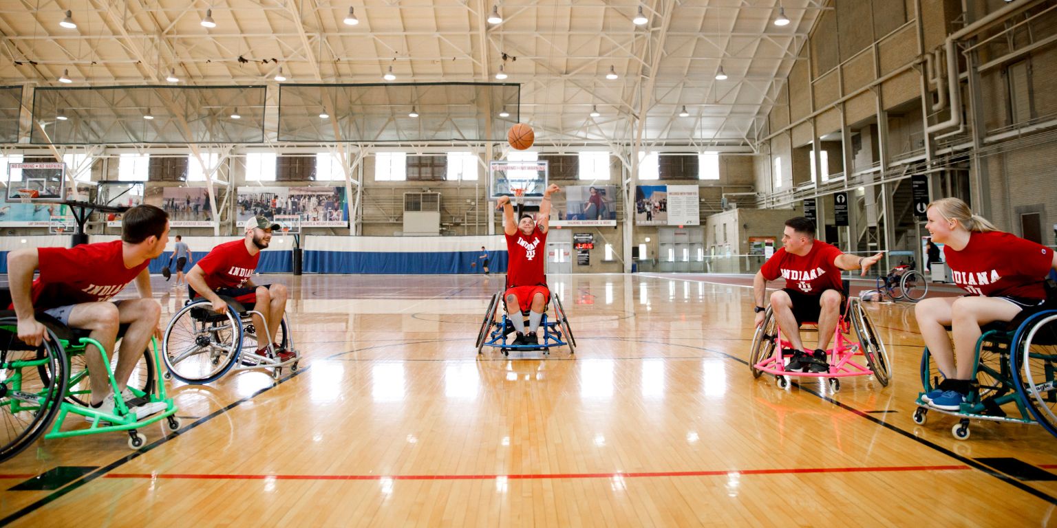Students playing basketball in wheelchairs 