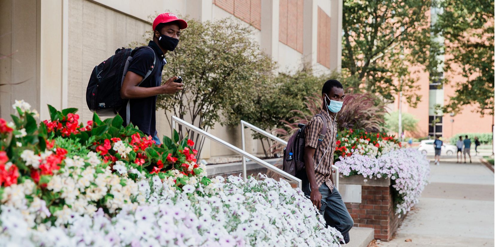 two students walking outside of Cavanaugh Hall