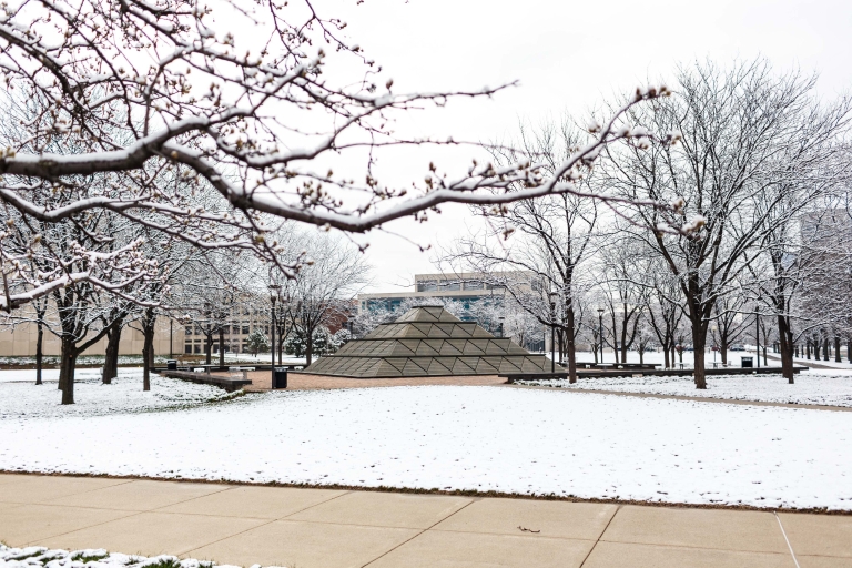 The library fountain is surrounded by a blanket of snow.