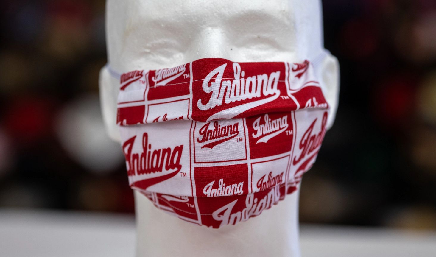 a mannequin head wears a red and white face mask with the word Indiana on it
