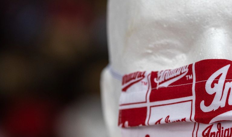 a mannequin head wears a red and white face mask with the word Indiana on it