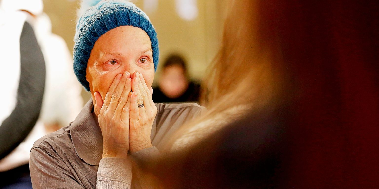 Kathy Rogers reacts with surprise after receiving a donation from students, staff and faculty
