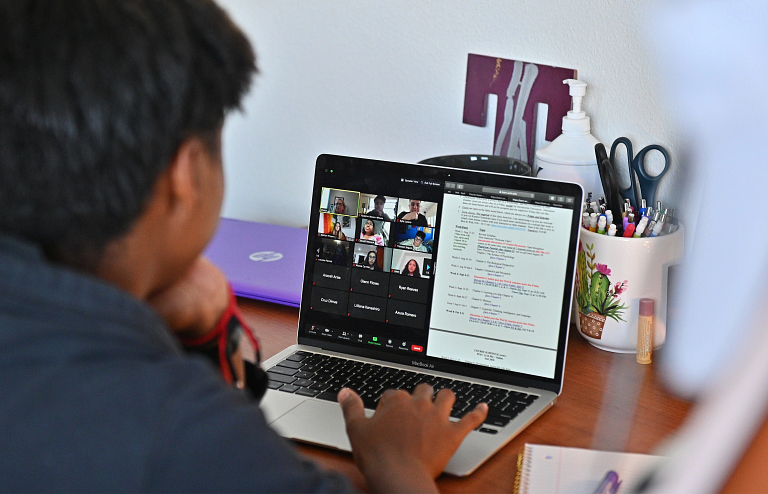 A student participates in a class online