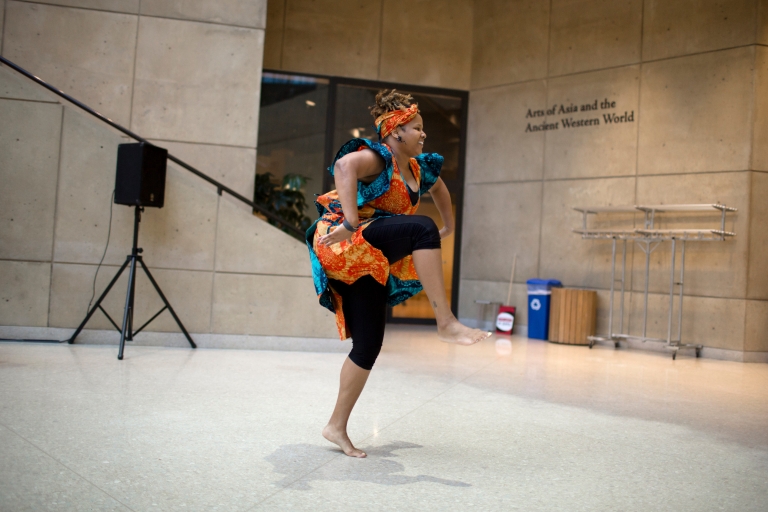A woman performs traditional African dance at the Eskenazi Museum of Art