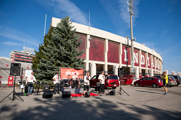 Don't Call Me Betty band performing in the parking lot outside Memorial Stadium