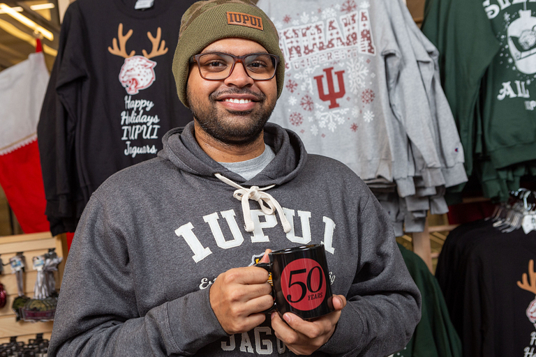 Karan Patel holds a coffee mug.